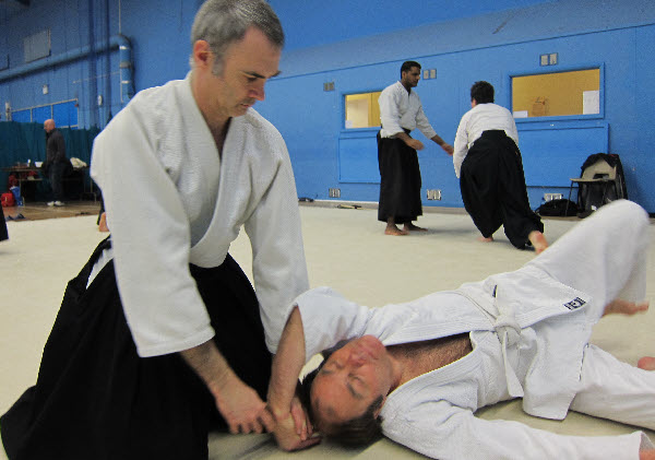 Shihonage aikido pin following the throw